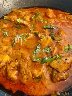 a close up of food in a pan on a stove