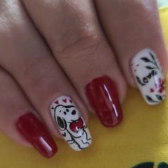 a woman's nails with red and white designs on them