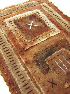 a close up of a piece of cloth with various stitches and crosses on the side