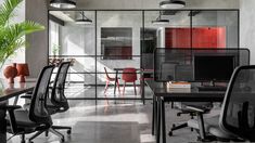 an office with black chairs and red accents