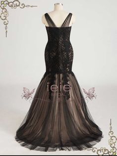 a black evening gown with an open back and sheer tulle, on display in front of