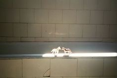 two toy horses are standing on the edge of a bathtub