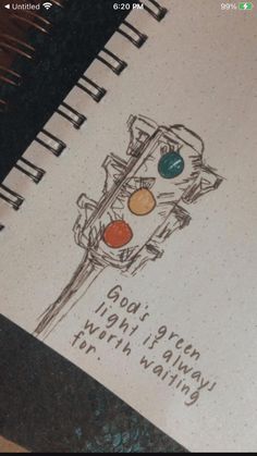 a spiral notebook with a drawing of a traffic light