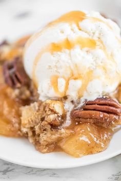 a close up of a plate of food with ice cream and pecans on top