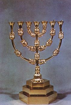 a golden menorah with many candles on it