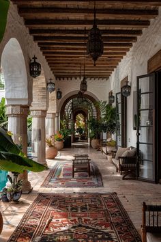 an outdoor area with lots of plants and rugs