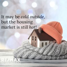 a house sitting on top of a pile of blankets with the caption century 21 it may be cold outside, but the housing market is still hot