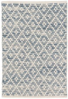 a blue and white rug with an abstract design