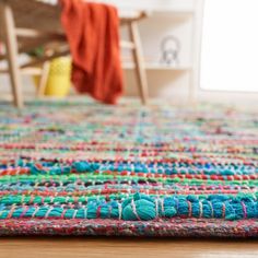 a multicolored rug on the floor in a room