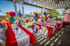 tables covered with red, white and blue tablecloths are set up for an outdoor party