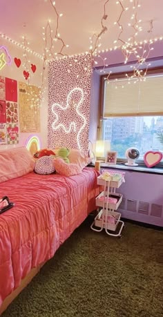 a bedroom decorated in pink and white with hearts on the wall, lights strung from the ceiling