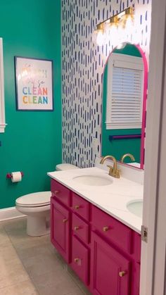 a bathroom with green walls and pink cabinets