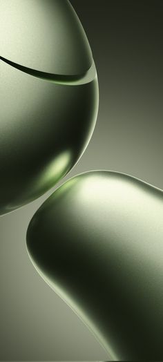 an abstract photograph of two green vases in the middle of each other's curves