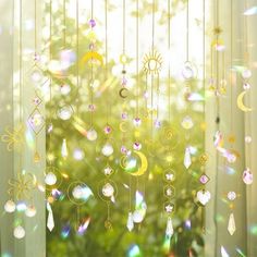 the sun shines brightly through the curtains in front of the window with beads hanging from them