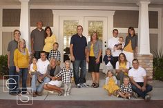 a large group of people are posing on the front porch