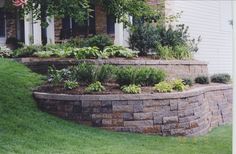 a brick garden wall in front of a house