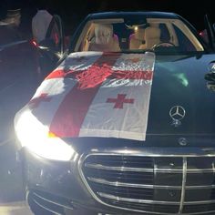 a car with a flag draped over it's head