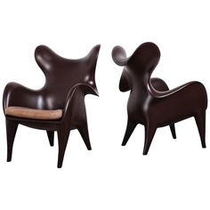 two brown chairs sitting next to each other