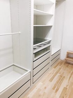 an empty white closet with drawers and shelves