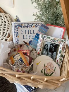 a wicker basket filled with plates and pictures