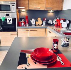 a kitchen with mickey mouse plates and utensils