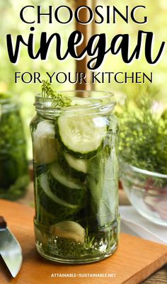 a jar filled with sliced cucumbers on top of a wooden cutting board