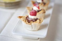 small desserts are sitting on a white plate