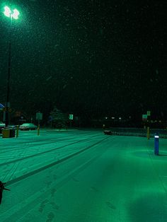 a person walking in the snow at night