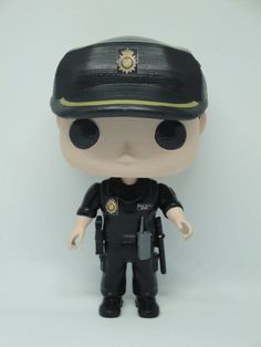 a toy police officer is posed on a white background