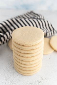 a stack of cookies sitting on top of a white counter next to a black and white towel