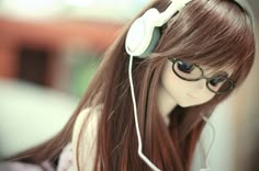 a doll with glasses and headphones on