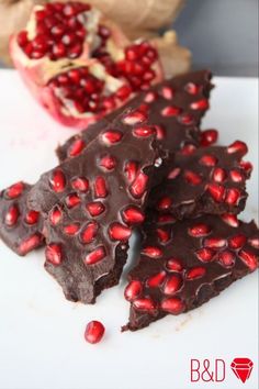 three pieces of chocolate with pomegranate on top