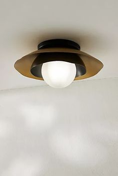 a light that is on the ceiling in a room with white walls and flooring