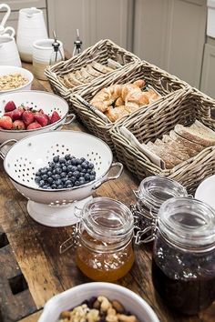 a table topped with lots of different types of fruit and pastries on top of it