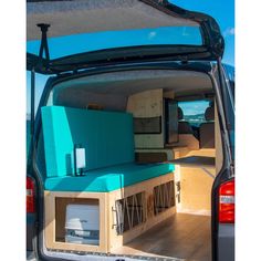 the back end of a van with its doors open and furniture in it's cargo area