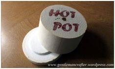 a toilet paper roll with the words hot pot on it sitting on a wooden table