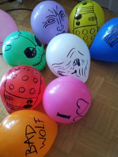 there are many different colored balloons with writing on them