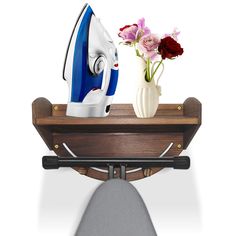 an ironing board and vase with flowers on it