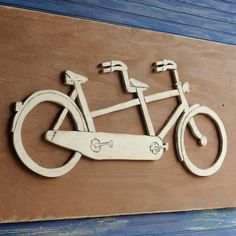 a wooden sign with a bicycle on it