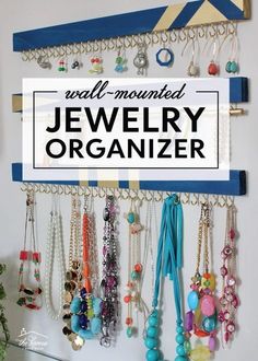 a wall mounted jewelry organizer hanging on a wall with the words well - organized jewelry organizer above it