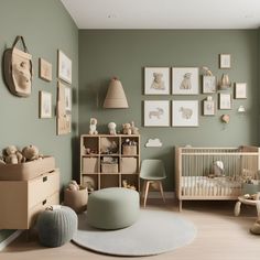 a baby's room with green walls and pictures on the wall