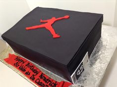 a birthday cake that is shaped like a box with a person on it and the words happy birthday to you in red