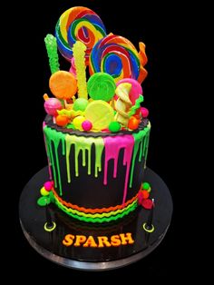 a birthday cake decorated with candies and lollipops