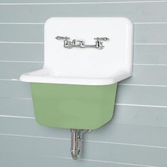 a green and white sink mounted to the side of a wall