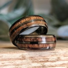 two wooden rings sitting on top of a table