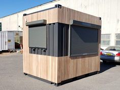 a small wooden structure sitting in the middle of a parking lot