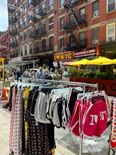 people are walking down the street in front of shops