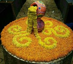 a large flower arrangement on top of a table with flowers in the shape of letters