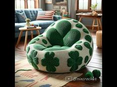 a green and white bean bag chair sitting on top of a wooden floor next to a blue couch