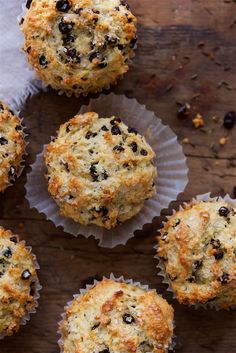 muffins with raisins and chocolate chips in paper cups on a wooden table